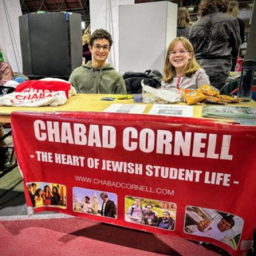 Two students at a Cornell Chabad table