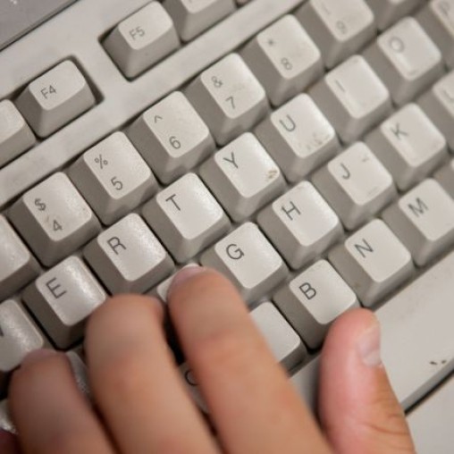 Hand typing on a keyboard