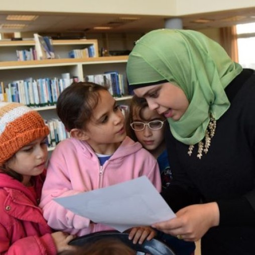 Muslim woman teaching Jewish and Muslim children