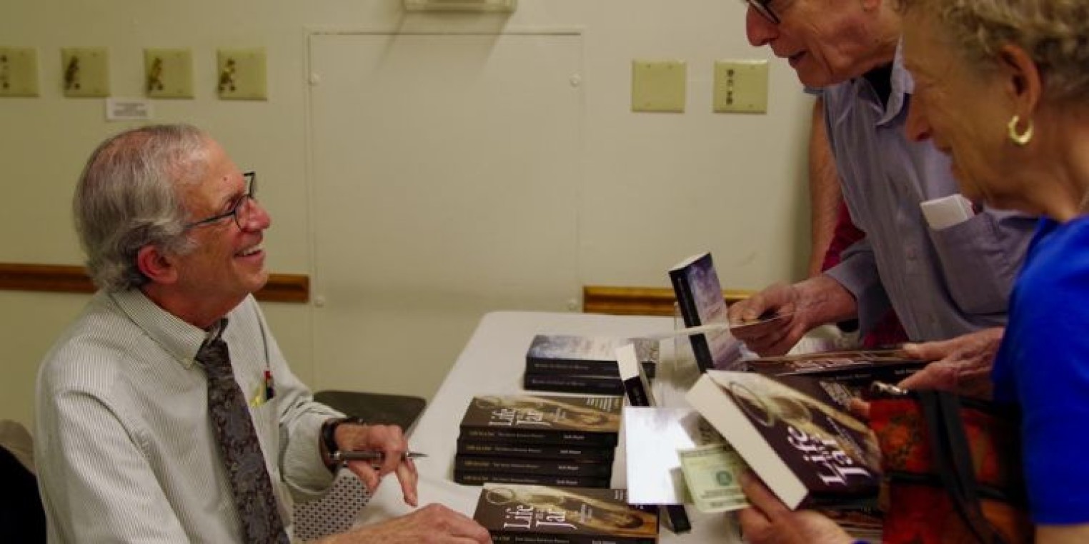 Jack Mayer signing books