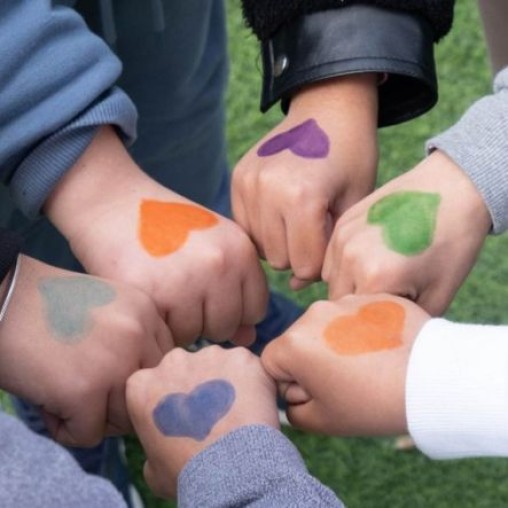 Six Children's Hands coming together in a fist bump