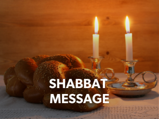 Two lit candles on a table next to a braided challah bread. The caption reads "Shabbat Message'," and links to Shabbat messages.