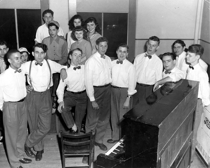 Members of a male glee club in the 1940s sing around a piano at Cincinnati's JCC