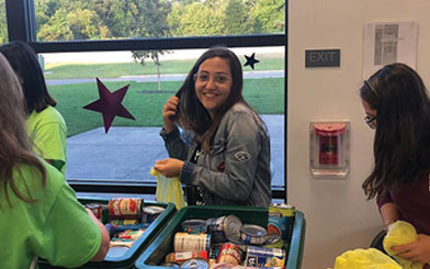 Dana-sorting-non-perishables-for-a-food-drive.jpg Dana sorting non perishables for a food drive