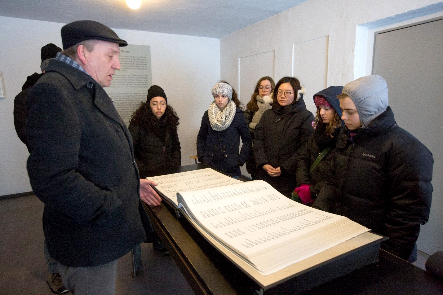 Students look at lists of names
