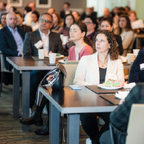 People sitting in the audience at a conference