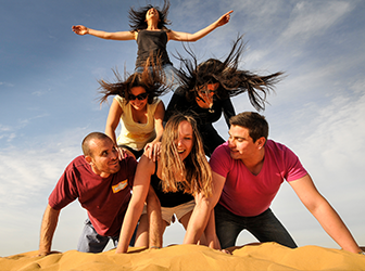 Teens making a human pyramid