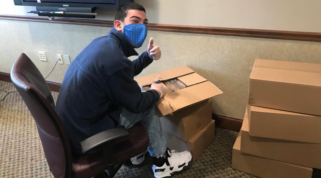 Marcus Apter, a volunteer at the Hartford JCC, packs boxes of Passover matzah for needy Jewish families in central Connecticut. (Courtesy of the Jewish Federation of Greater Hartford)