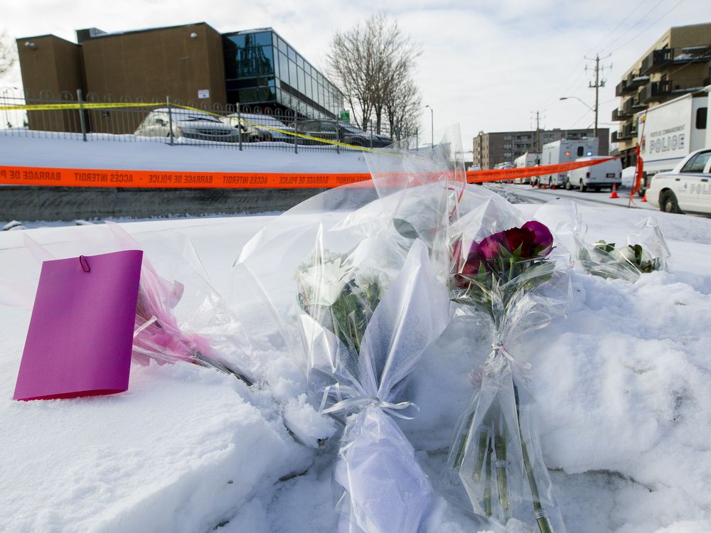 Bouquets lay in the snow near the entrance to the Centre Culturel Islamique de Québec (background) in Quebec City Jan. 30, 2017.Phil Carpenter / Montreal Gazette