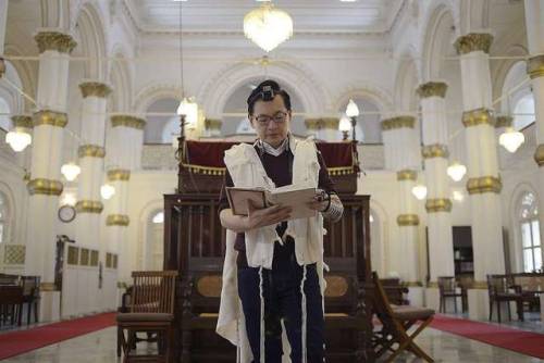 Jewish man prays at the Chesed-El Synagogue in Singapore; 2016.